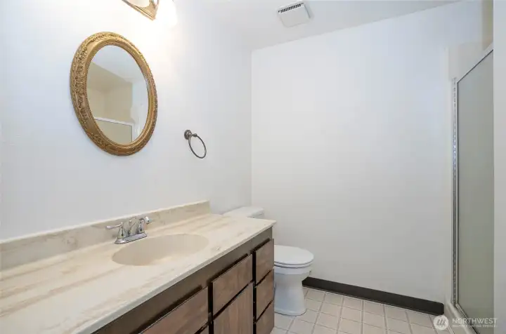 Primary suite bathroom with a private walk-in shower.