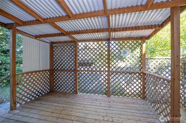 Step through the sliding door from the dining area onto the covered deck.