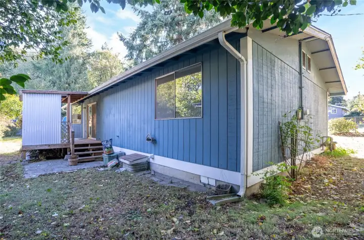 Rear exterior of the home with covered deck.