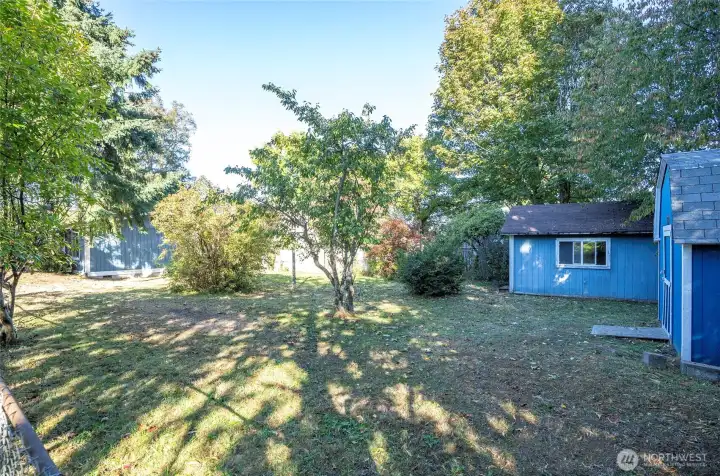 Perspective from the corner of the fully fenced yard looking toward the home.