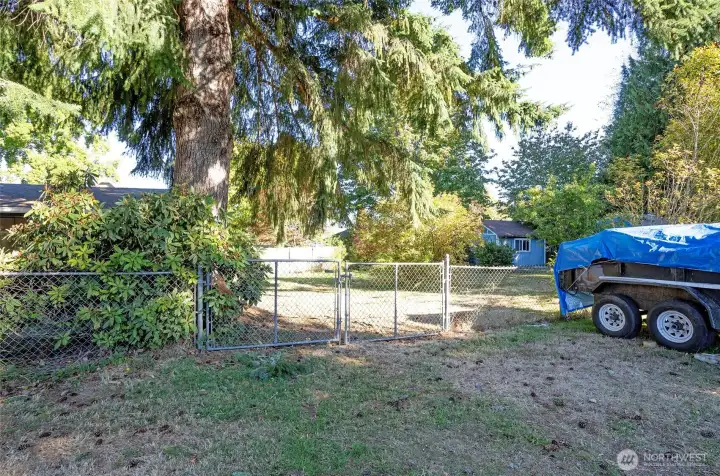 Convenient gate provides access to the fully fenced yard—plenty of room for RVs, toys, or outdoor equipment.