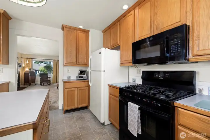 Another view of the kitchen with the newer microwave and range that were placed in 2022.