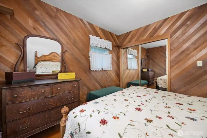 Another view of the primary bedroom with the large closet that has mirrored sliding doors.
