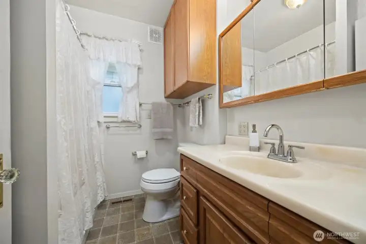 The full bath is on the main floor and has a large vanity with additional storage.