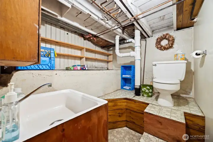 There is a half bath in the basement with a deep sink.