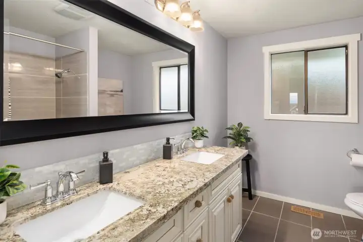 2nd full bath on main level with double sinks and ample storage