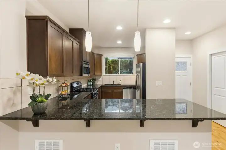 Kitchen with slab granite counters
