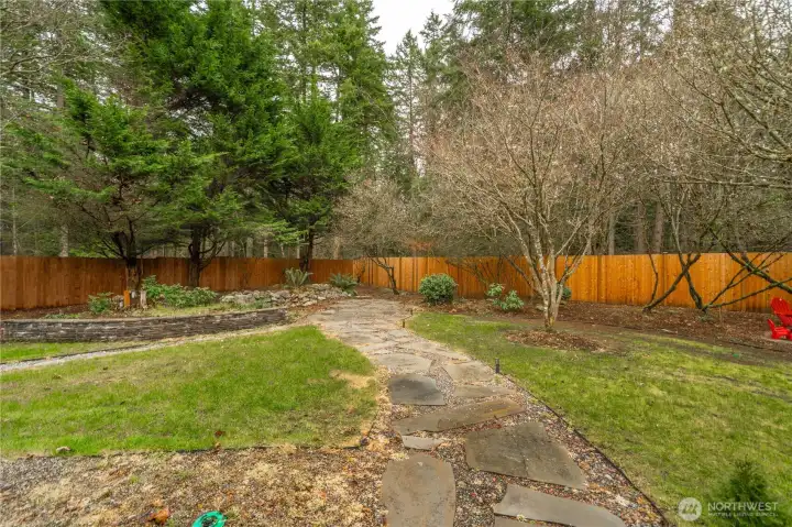 Landscaped backyard with newly added cedar fence for privacy - home backs up to the Cedar River Trail