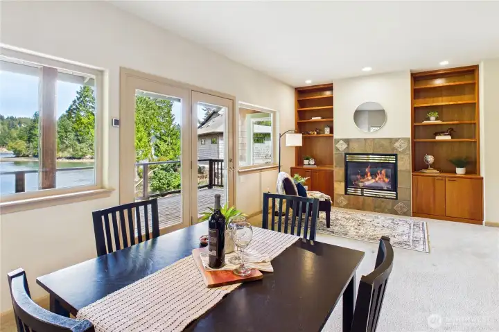 Use this as additional dining space, or use as a family room. Note the second propane fireplace and custom built-ins as well as French doors to the deck.