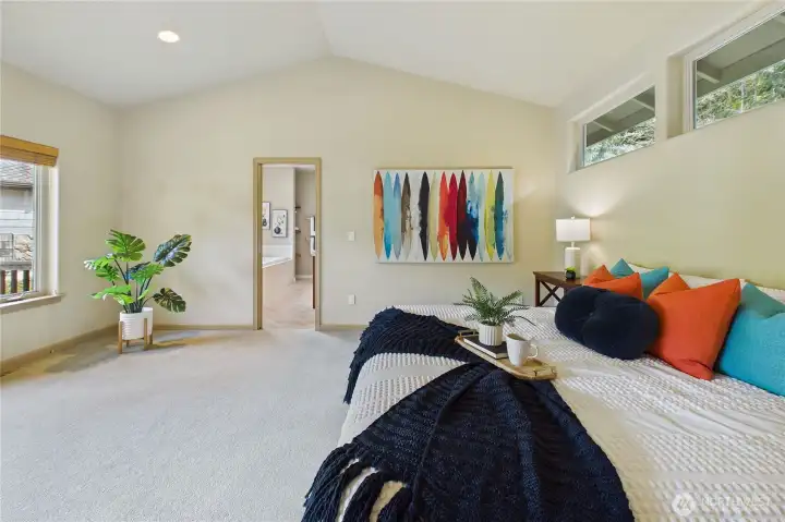 Another view of the primary bedroom with the bath/closet beyond.