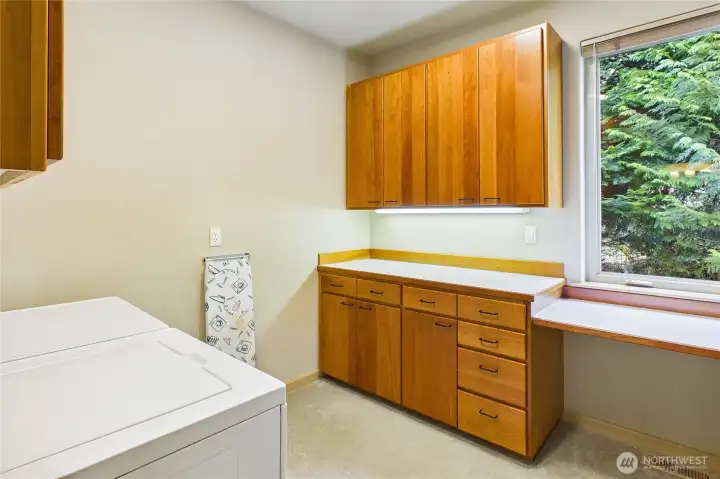 Rounding out the main floor is the good-size utility room, also with the custom cherry cabinetry.