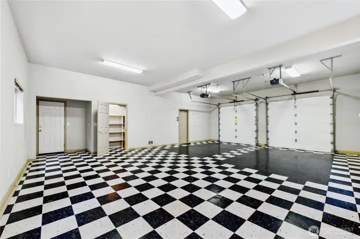 Beautifully finished extended garage space with pantry/storage and man door to the exterior.