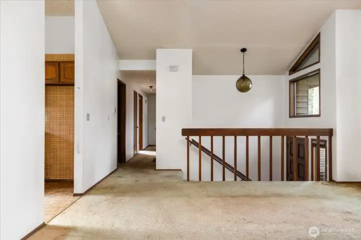 Looking down the hallway with the kitchen on the left and bedrooms at the other end.
