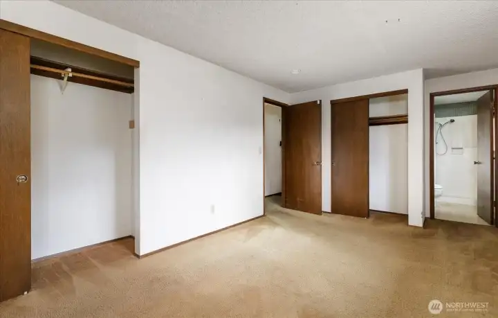 Two closets and a 3/4 bath make this primary bedroom pretty "suite".