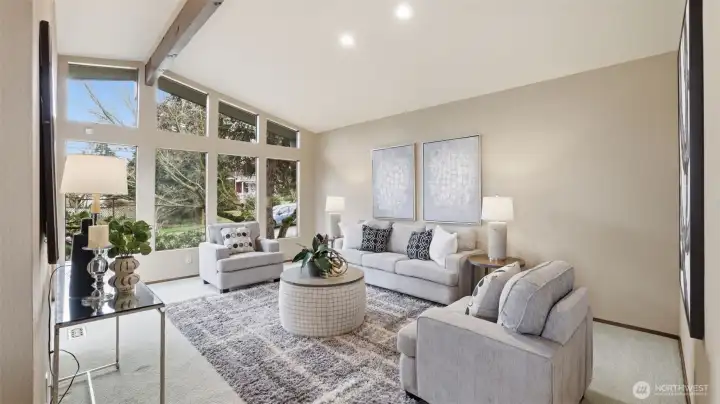 Large windows fill the living room with abundant natural light.