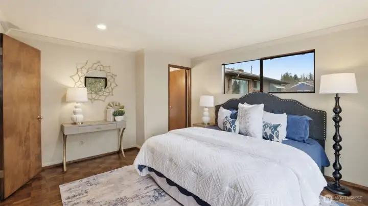 The primary bedroom with an en-suite bath is a relaxing space designed as a quiet retreat.