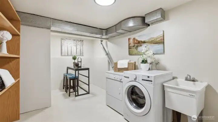 Functional laundry room with storage and convenient sink.
