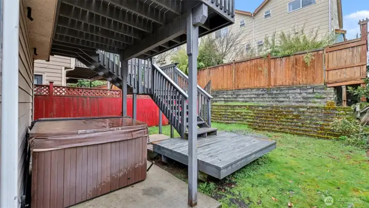 This backyard offers layered outdoor spaces for relaxation and entertaining.