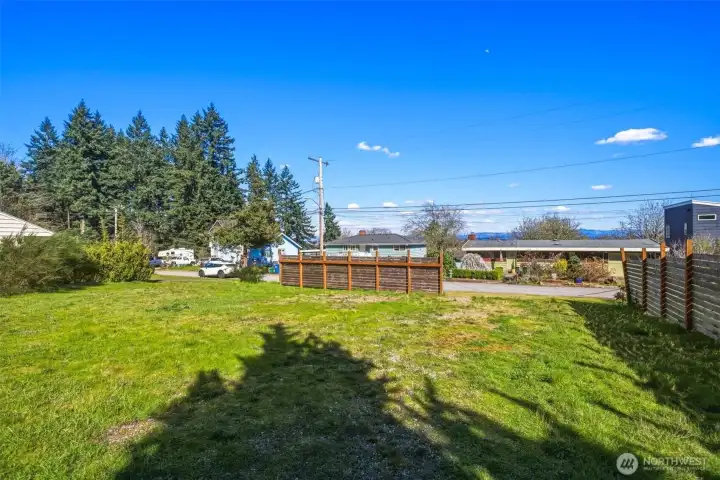 Ground view showcasing flat, buildable lot in Southwest Seattle neighborhood