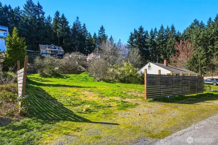Front-facing view of property with street access and utilities nearby