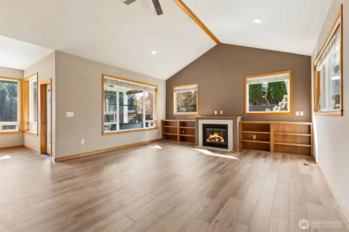 The sunshine pours into this space from every window  look at that reflection off the floor & brand new flooring