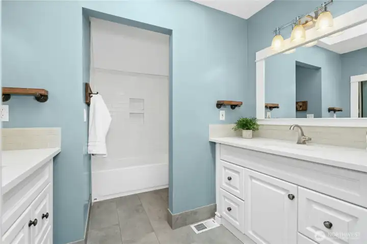 Two sinks and tiled shower in Upper Level Full Bathroom