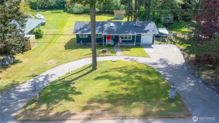 Front of home & paved circular driveway from above