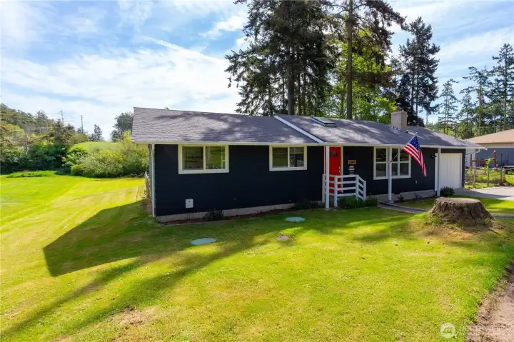 Front and side of home looking at back yard & all that lush grass