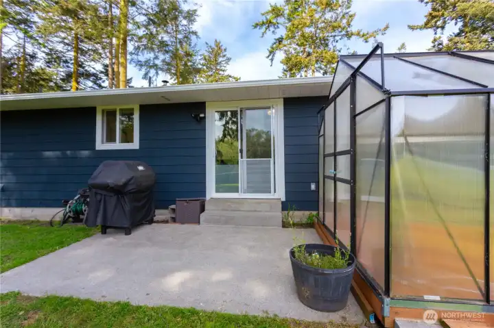 Rear patio off kitchen/dining area, perfect for outdoor cooking