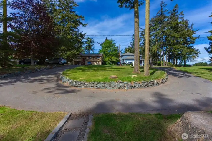 Looking out from house toward road and paved circular driveway