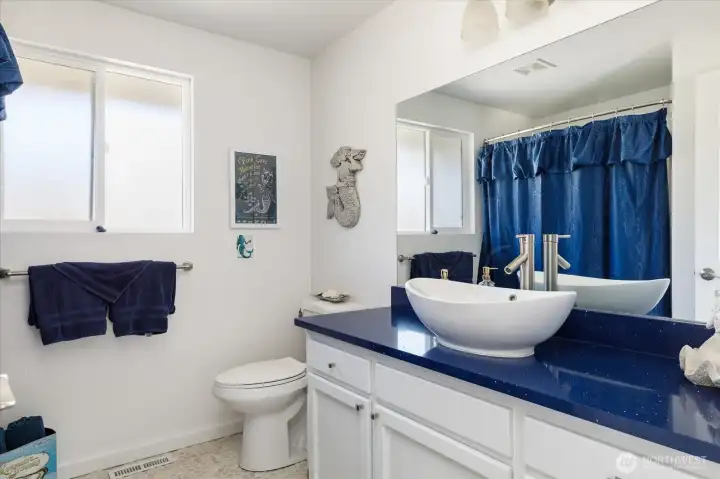 Main bathroom with tub and shower.