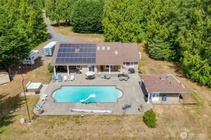 Great view of the back pool area and pool house with 3/4 bath, kitchen area too.