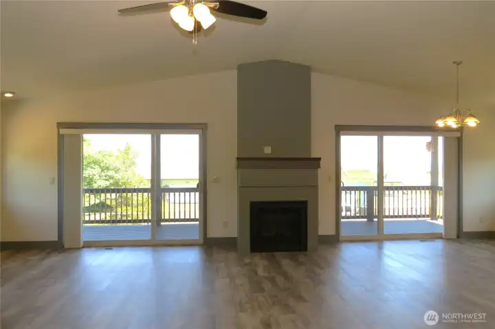 The spacious great-room showcases designer colors, waterproof luxury vinyl plank flooring, vaulted ceilings and cozy propane fireplace The spacious great-room showcases designer colors, waterproof luxury vinyl plank flooring, vaulted ceilings and cozy propane fireplace