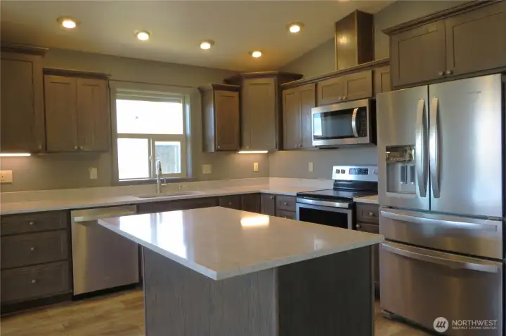 The kitchen has elegant quartz coo9untertops and a generous center island with matching stainless steel appliances! The kitchen has elegant quartz coo9untertops and a generous center island with matching stainless steel appliances!