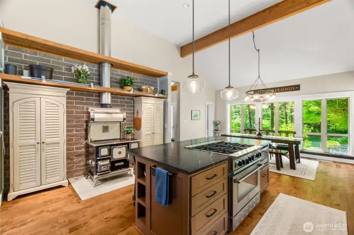 The Elmira Sweetheart woodburning range works great! the brick wall behind is designed to retain heat and disburse throughout the day. So energy efficient!