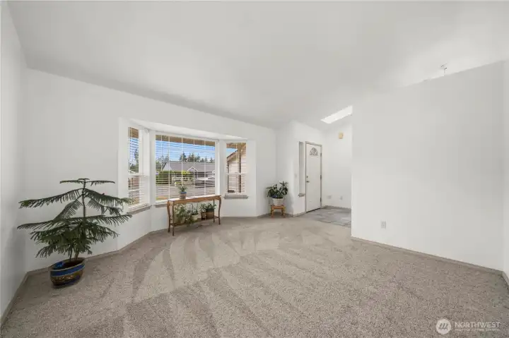 Directly to your right is a large family room with a grand window to funnel in tons of natural light. Directly to your right is a large family room with a grand window to funnel in tons of natural light.