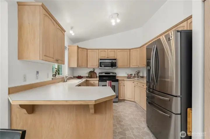 Breakfast bar for quick meals + additional counter space. Breakfast bar for quick meals + additional counter space.