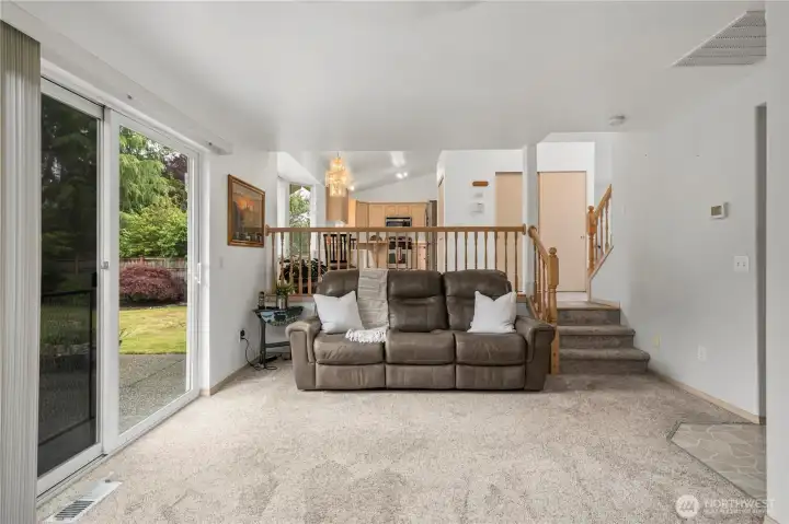 Spacious living area has direct access to guest half bathroom and laundry room + sliders to the large backyard. Spacious living area has direct access to guest half bathroom and laundry room + sliders to the large backyard.