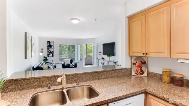 Kitchen features granite counters, tons of cabinet and counter space, eating area & laminate floors. All appliances stay!