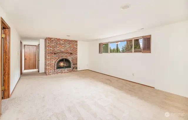 Lower level living / rec-room facing wood burning fireplace