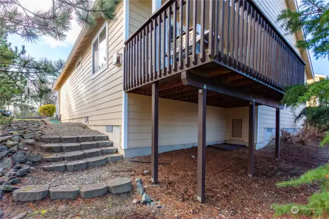 under deck door to spacious lighted storage area under home