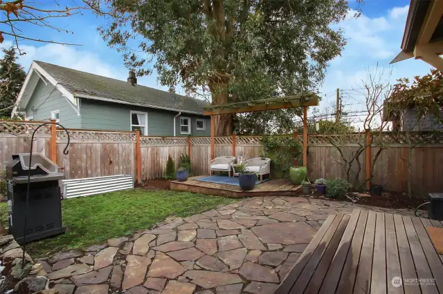 Flagstone patio, deck with arbor, & raised planting bed, too!