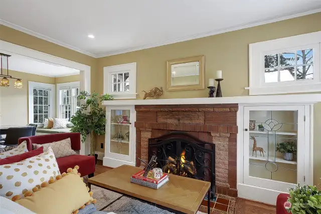 The cozy period fireplace features beautiful built-in cabinets.