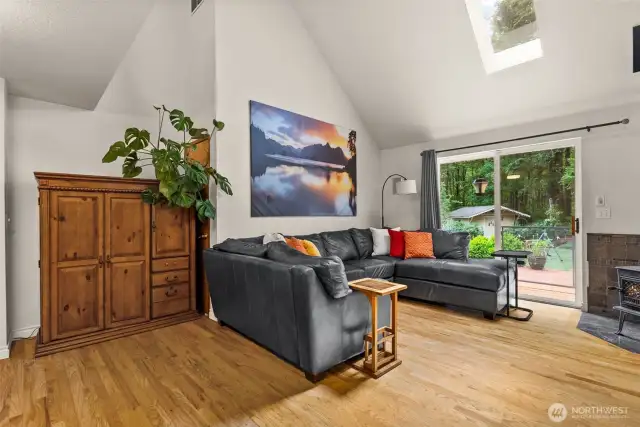 Living room with sliding doors to deck and wood stove