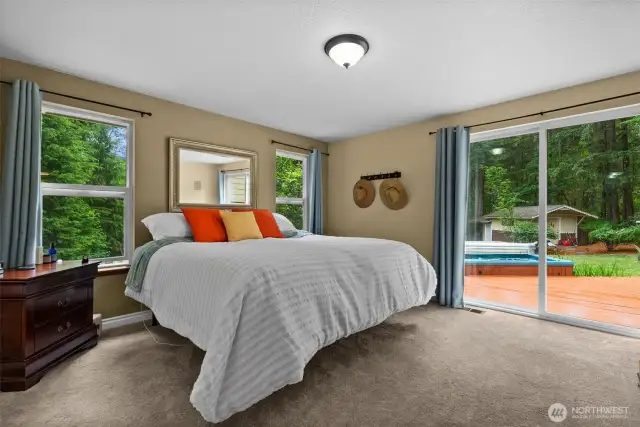 Main floor primary bedroom with sliding door to hot tub