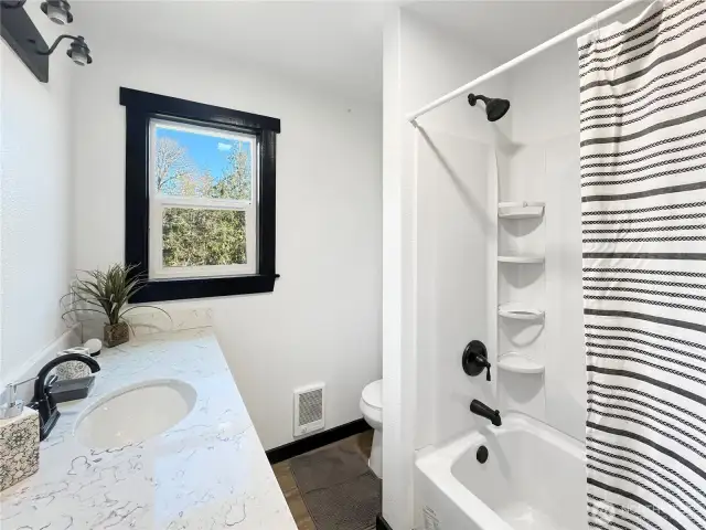 Updated and clean bathroom with a full tub/shower combo and fresh finishes.