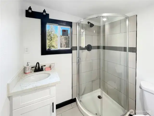 Smartly laid out 3/4 bath with walk-in shower and modern finishes.