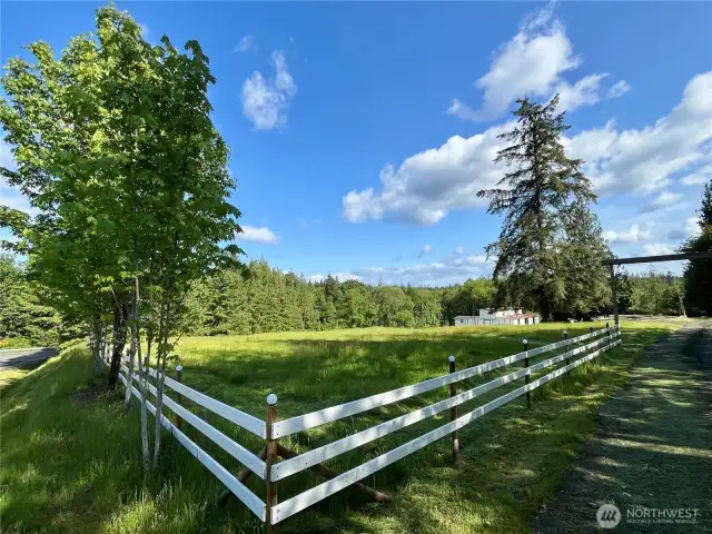 Peek beyond the fence—3.65 acres of country living with a horse pasture and endless possibilities.