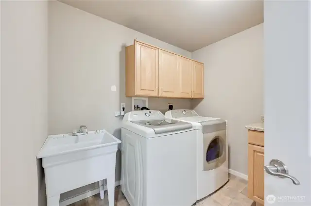 Lower level laundry room with utility sink.  Washer and dryer stay.