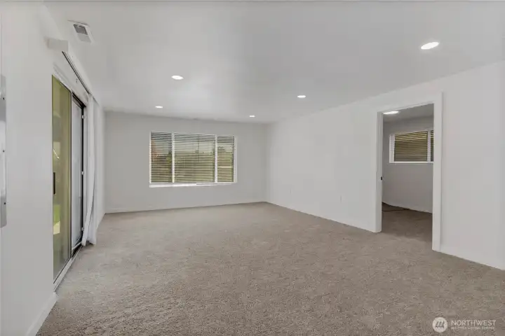 The roomy family room is carpeted for cozy gatherings